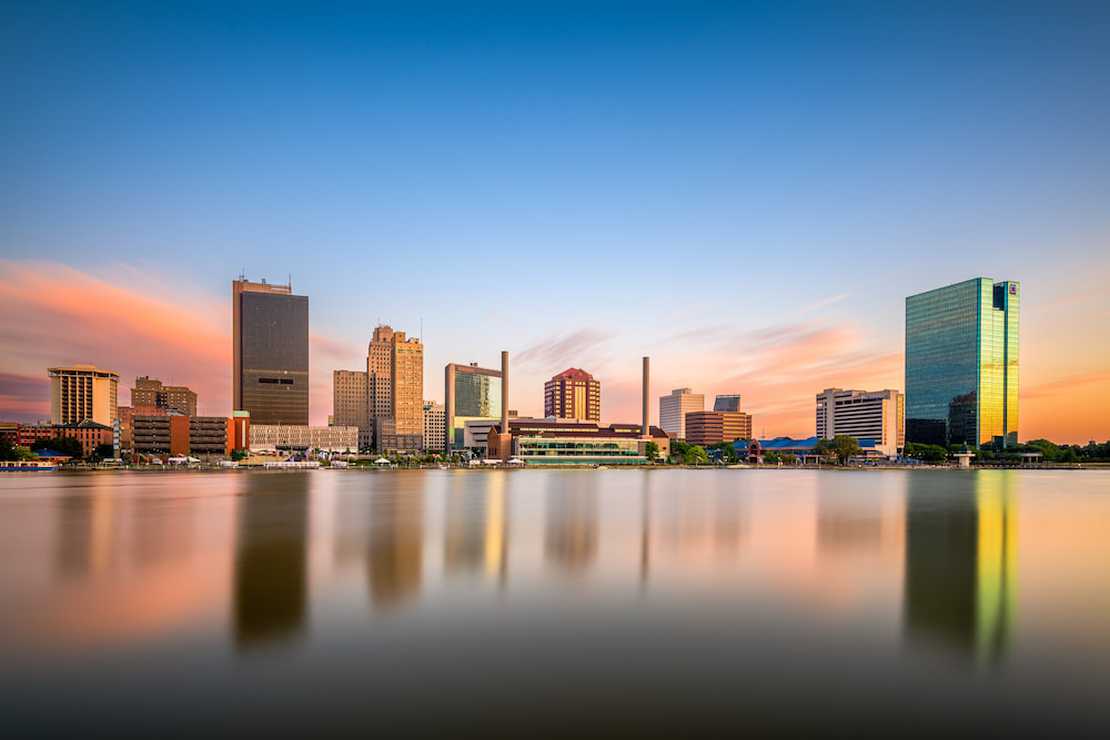 Toledo, Ohio, USA downtown skyline on the Maumee River at twilight.